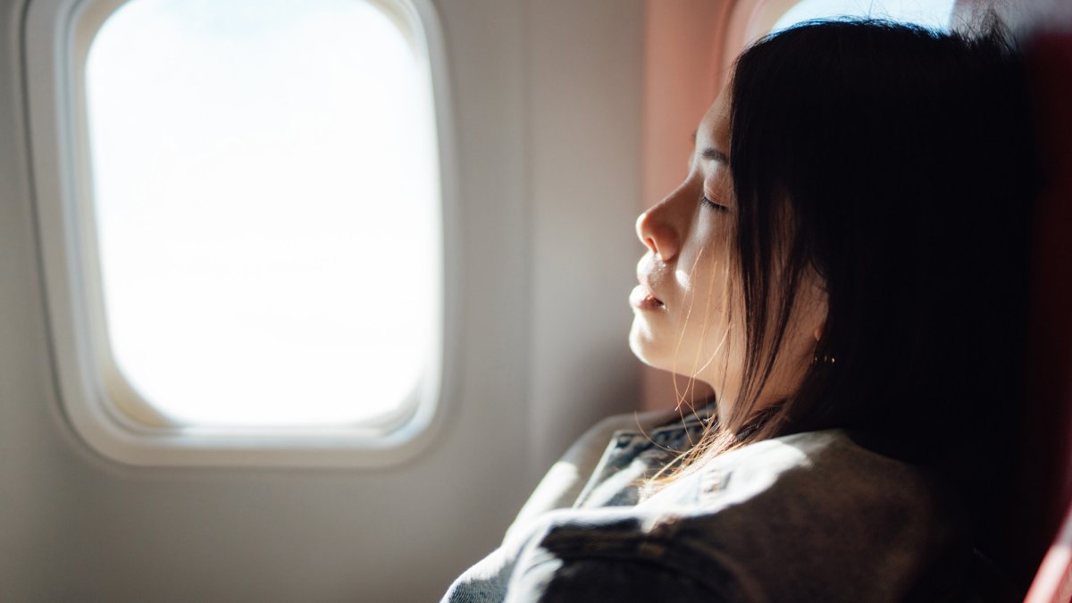 The best way to sleep on a plane, according to science