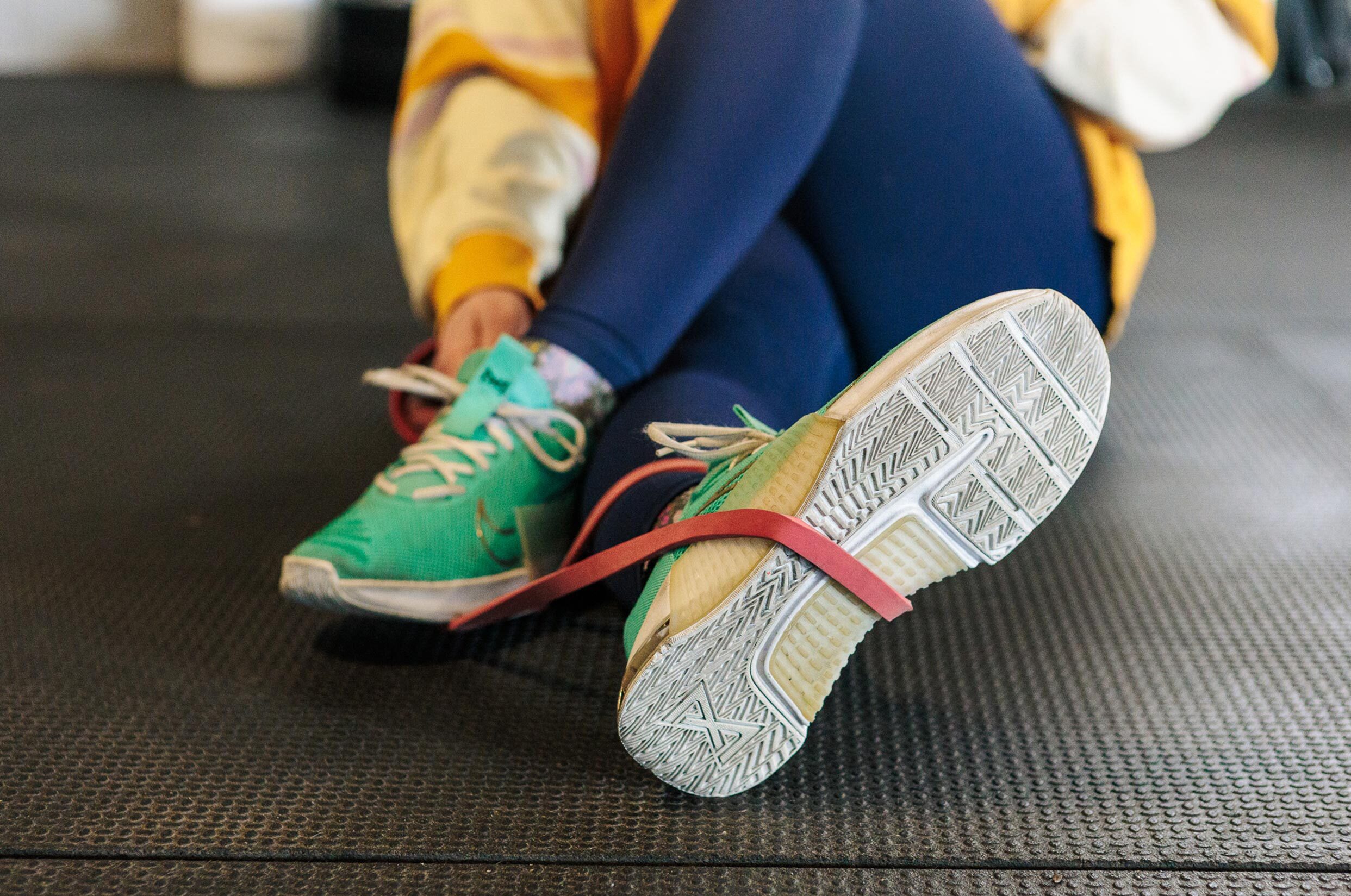 two feet crossed over with resistance band on shoes