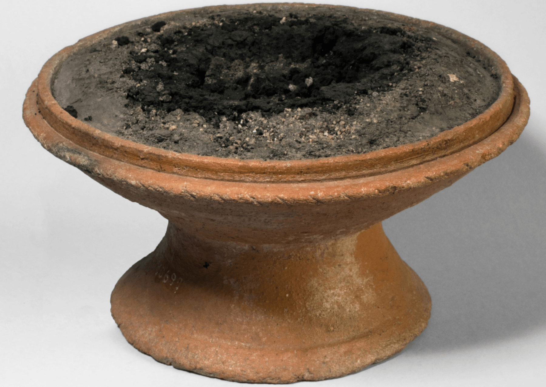 an circular incense burner with volcanic ash on top