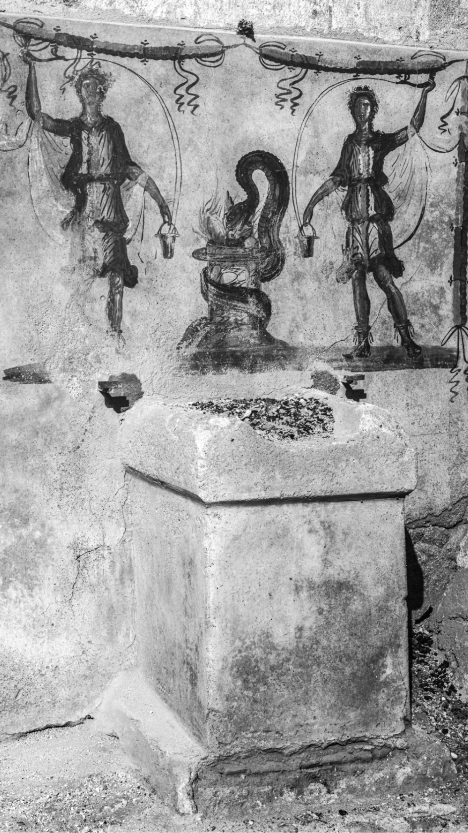 Pompeian street altar with painted images of gods and ash residues from the last sacrifice performed there. Photo from 1915.