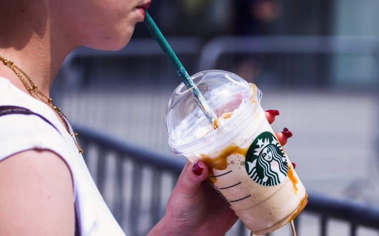A person drinks Starbucks ice coffee in Krakow, Poland on June 7, 2025. (Photo by Beata Zawrzel/NurPhoto)