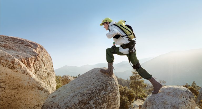 New Hypershell X Series exoskeleton on someone climbing up rocks