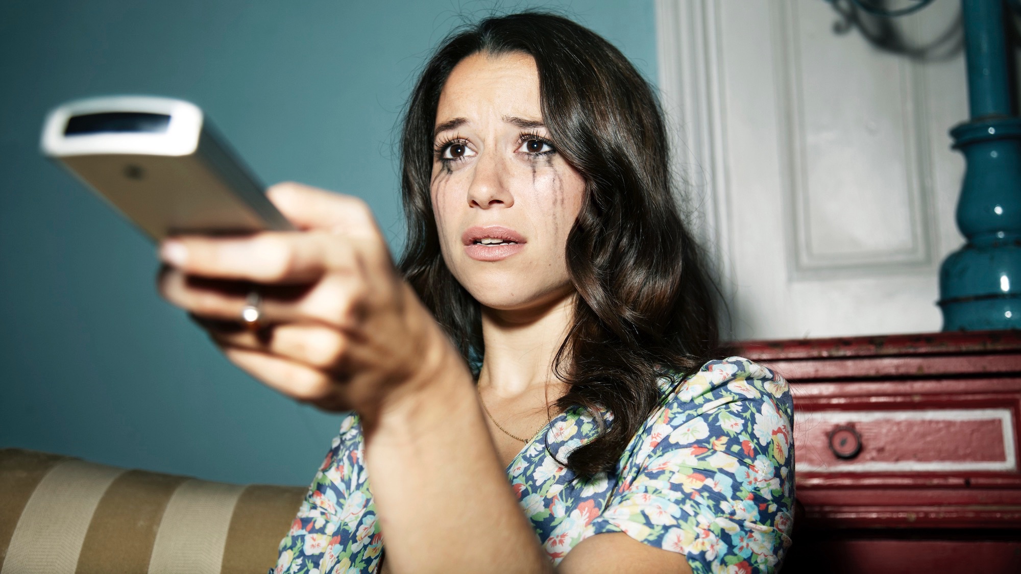 Woman crying while watching TV