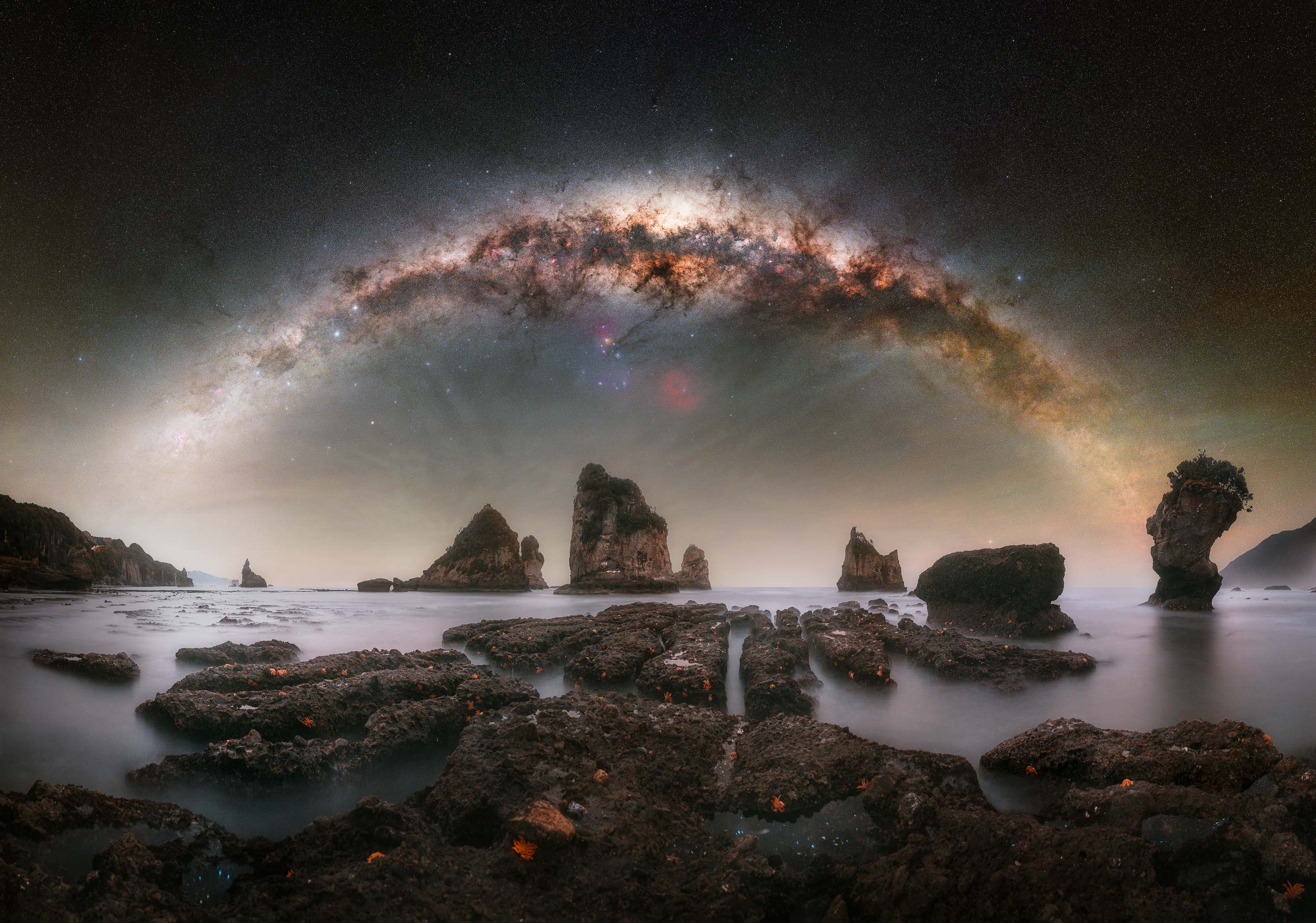 Capturing a setting Milky Way core from this beach had been on my list for a long time, with the starfish-covered reef offering a distinctive and compelling foreground. It’s a notoriously difficult scene to photograph, as access to the reef is only possible during the lowest tides, while the sky must also cooperate with favorable moon and cloud conditions. During my short visit, everything unexpectedly aligned. At first, the conditions seemed uncertain due to strong winds, but I decided to attempt the shot with some company for safety. After assessing the reef, I carefully made my way onto it while others kept watch to ensure I remained safe. The terrain is hazardous, with gaps between the rocks posing a real risk, and the rapidly rising tide added constant pressure throughout the shoot. Despite these challenges, I was able to capture the necessary frames, returning to shore just in time. Due to the changing tide, the upper rows of the sky panorama were photographed from the beach, while the lowest row was captured from the reef to maintain proper alignment and perspective in the final composition.