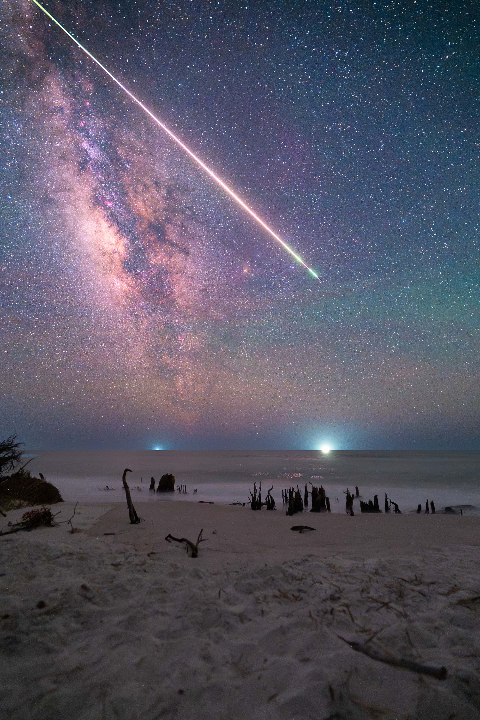 This single-exposure image became a reminder to always expect the unexpected in astrophotography. I had not even planned to visit this beach, as the forecast called for clouds and rain throughout the night. The capture was part of a larger day-to-night time-lapse that I began shooting at golden hour, working through biting insects and the intense tropical humidity of Florida. After setting up the sequence, I left the camera running and returned to my vehicle. Several hours later, shortly after midnight, I noticed the ground around me suddenly illuminated by a green glow, prompting me to look up. What followed was the largest meteor I have ever witnessed. It moved slowly across the Milky Way for nearly five seconds, and the glowing trail left behind by the fireball remained visible for almost fifteen minutes. It was one of the most memorable moments I have experienced in astrophotography, completely unplanned and impossible to anticipate.