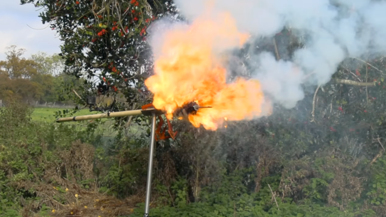 Large flaming dart on stand outside