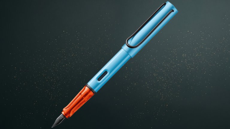 A denim blue LAMY AL fountain pen on a speckled Father's Day gift guide background