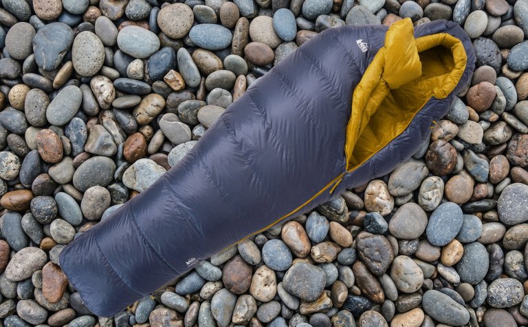 REI Co-op Magma 30 Sleeping Bag on a background of stones
