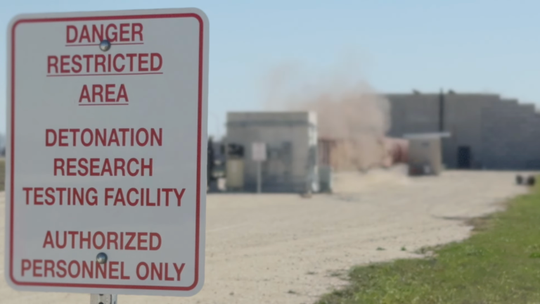 a warning sign in front of a building for explosions