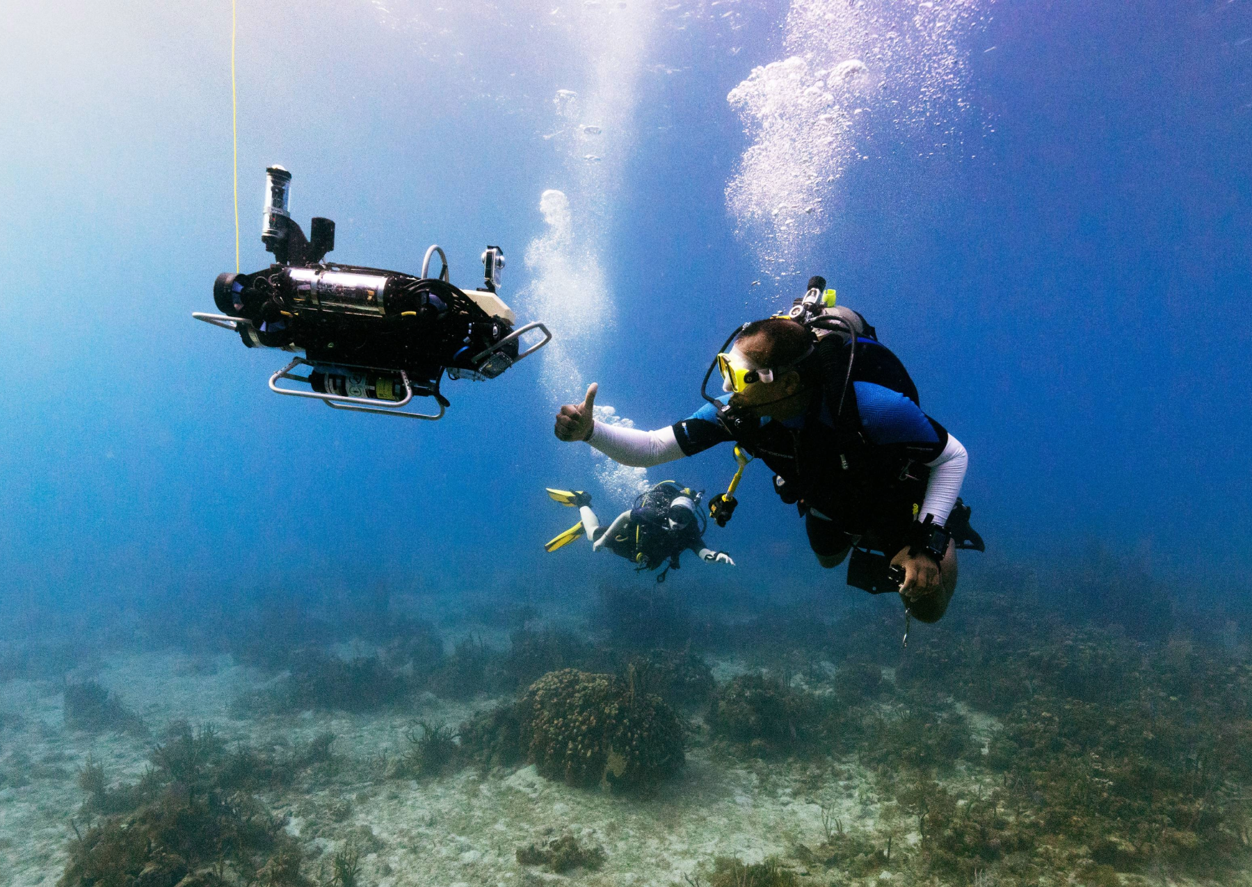 a diver gives a robot a thumbs up