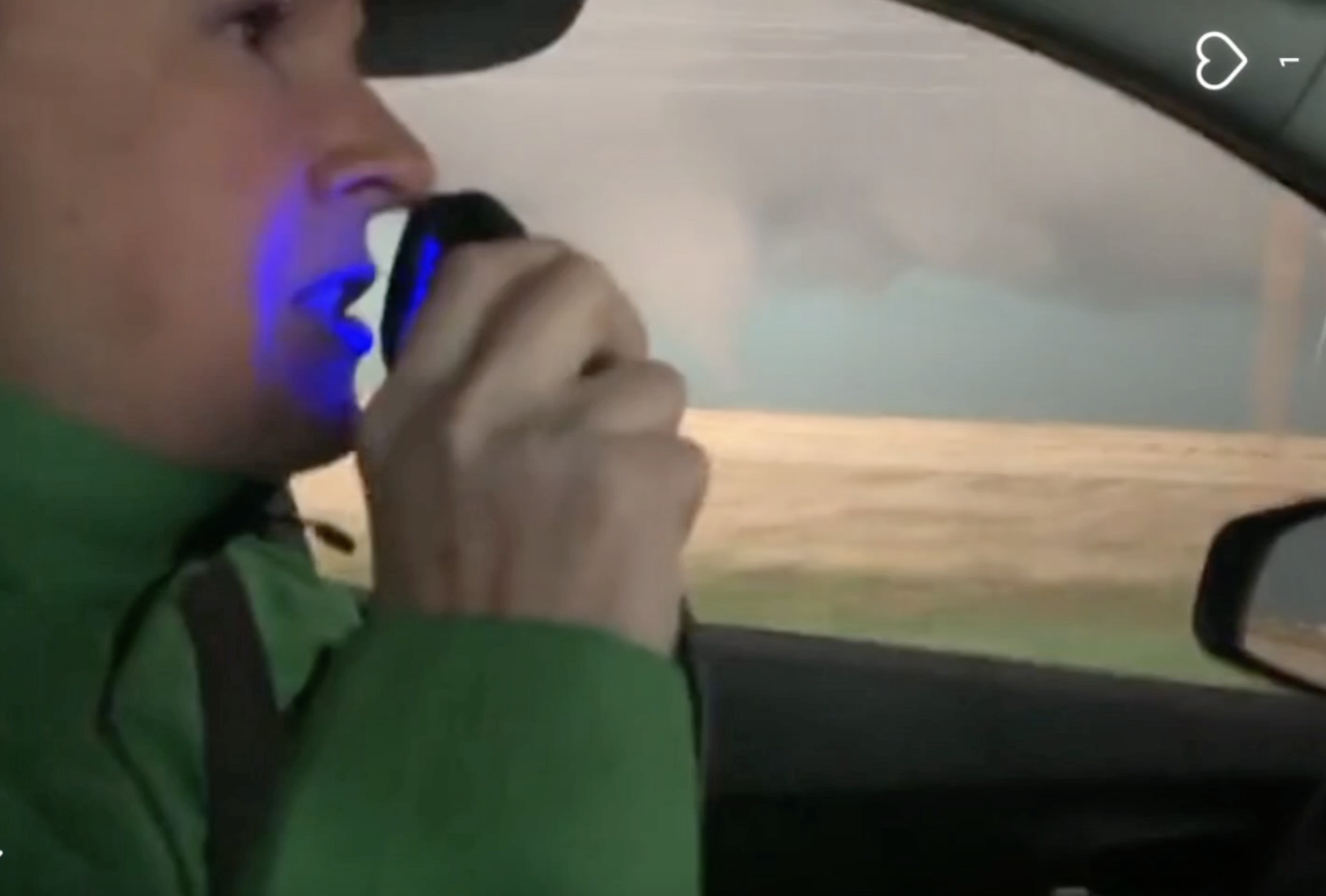 a woman driving while operating a car radio