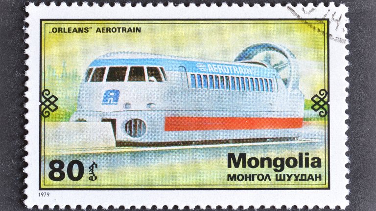 1979 postage stamp showing a futuristic hovertrain along a rail with a fan on the end on a yellowish background.