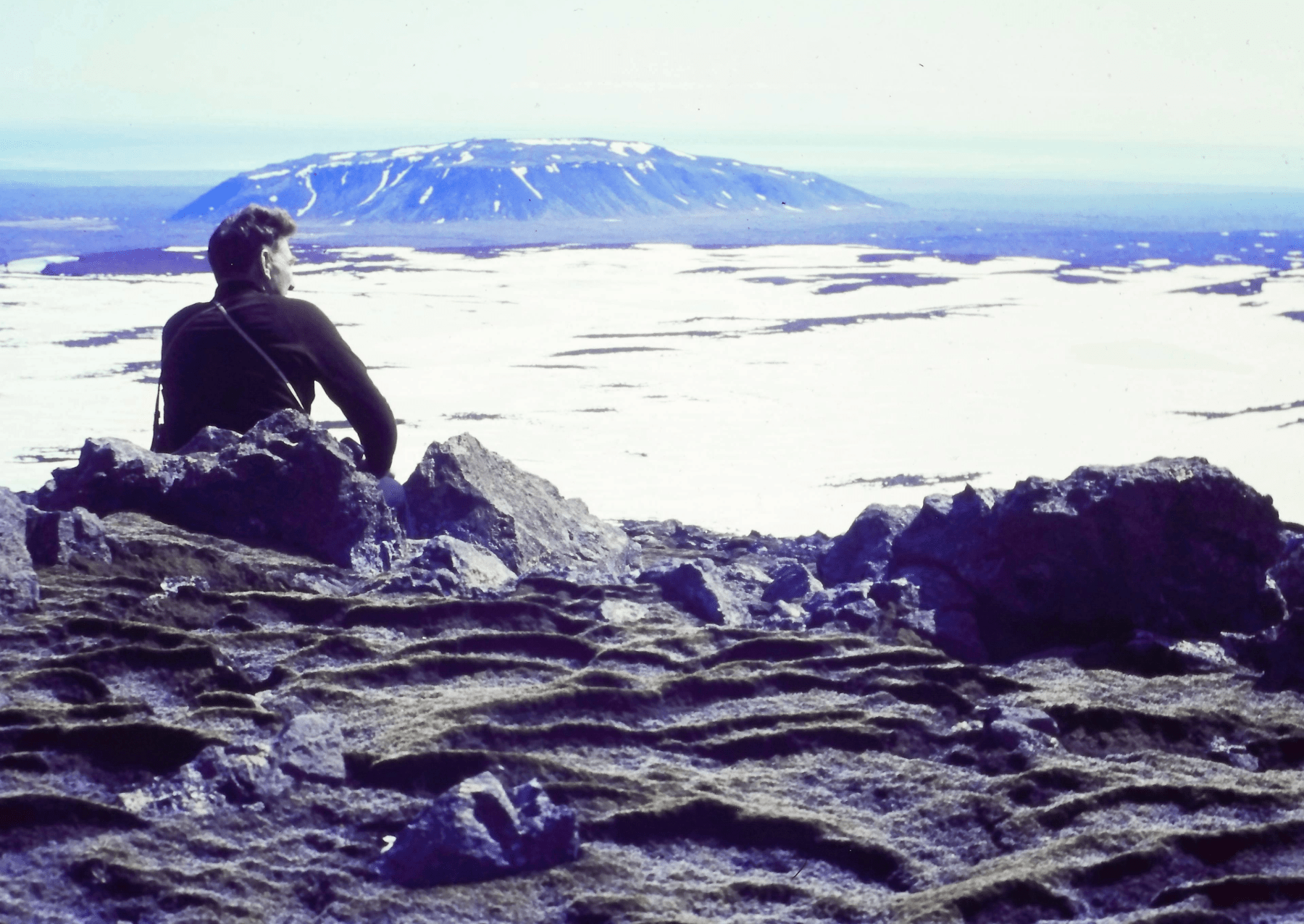 Icelandic Glaciological Society member, Árni Kjartansson, sits overlooking a glacier in Iceland. Image: Archival Materials Courtesy of Andri Snær Magnason.