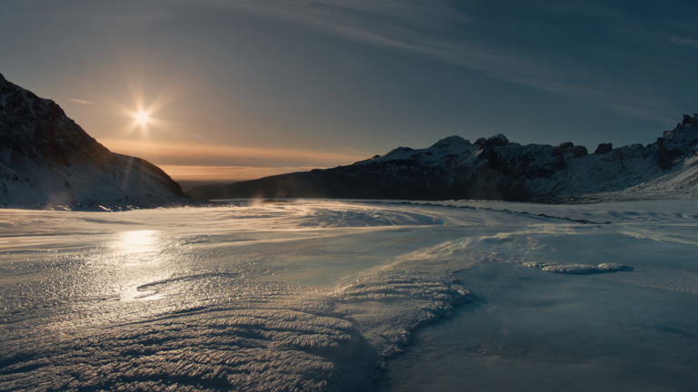 a sunset over a glacier