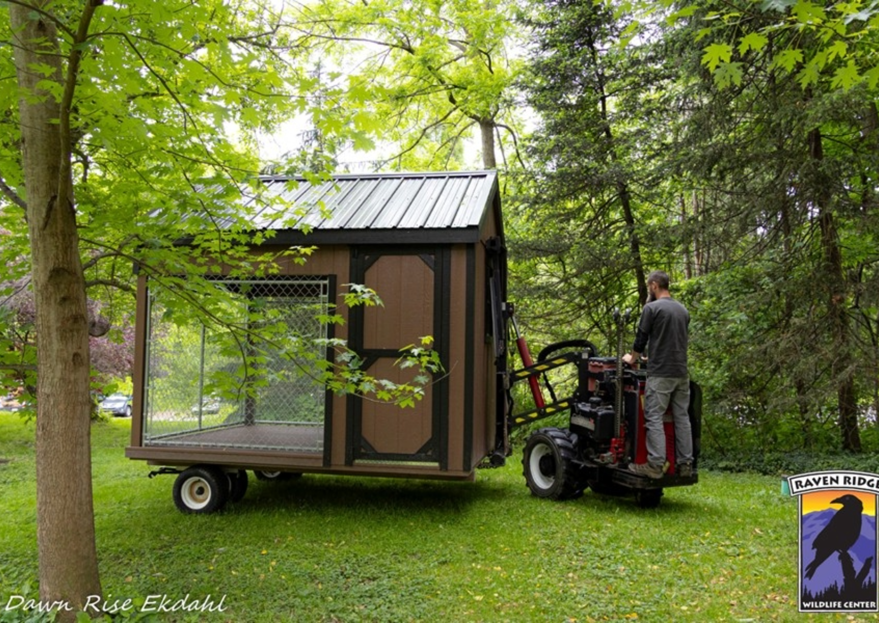 a man moves a kennel on a forklift