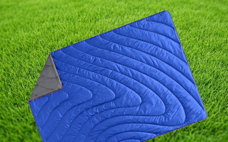 Rumpl outdoor blanket against a grass backdrop