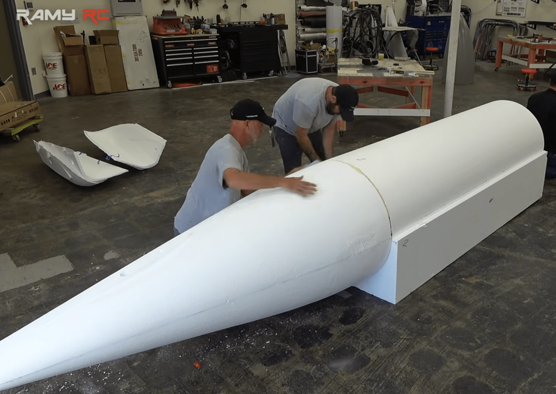 two men building a plane using white molded foam