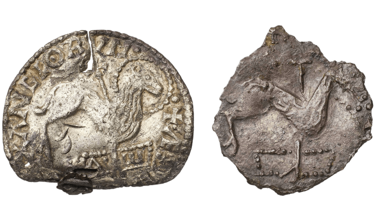 The front of the coin represents Christ’s crucifixion (right). The reverse side has the Greek letters alpha and omega, symbolizing God as the beginning and the end (left).