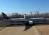 a man sitting on a large remote-controlled plane