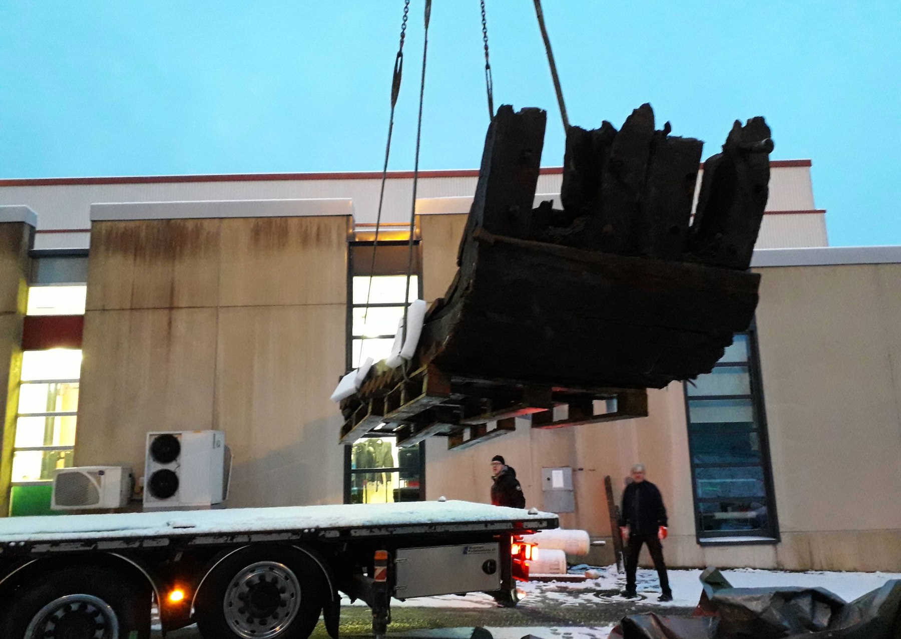 a piece of wood being lifted into a lab
