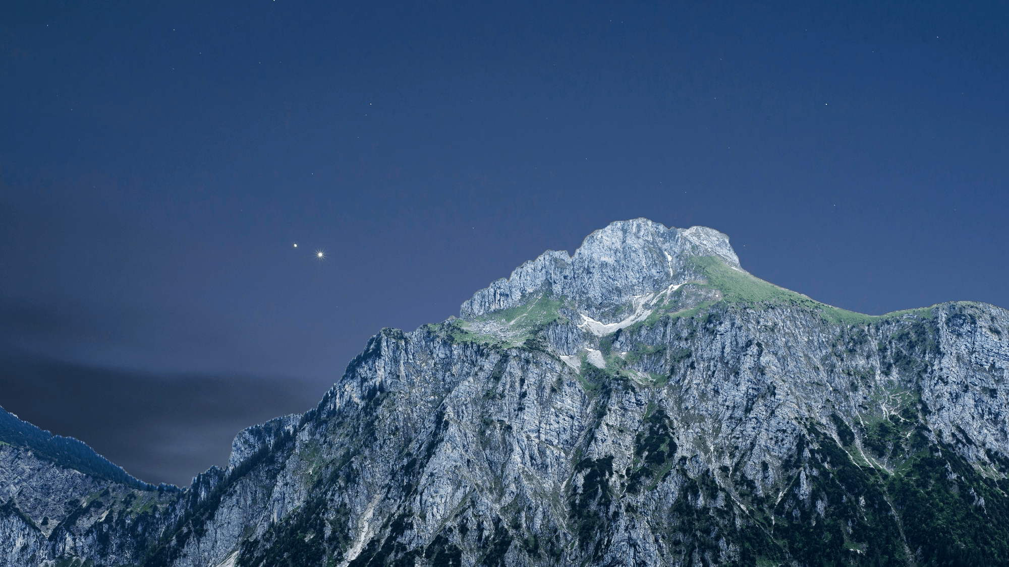 two shiny planets next to a snowy mountain