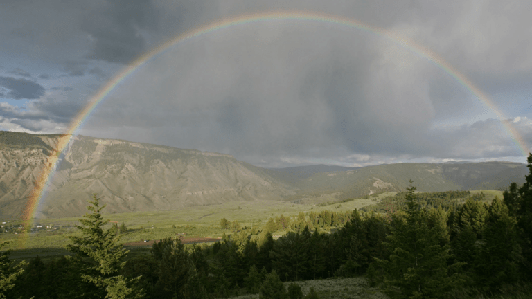 a rainbow over a hot spring