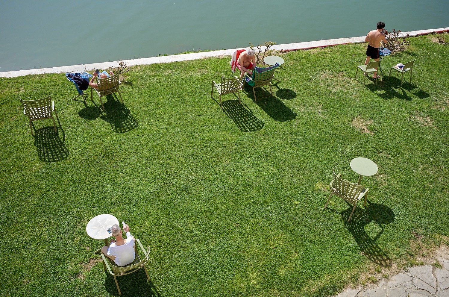 people sitting at tables on grass