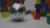 Aluminum 120-sided die with multicolored blocks on table behind it