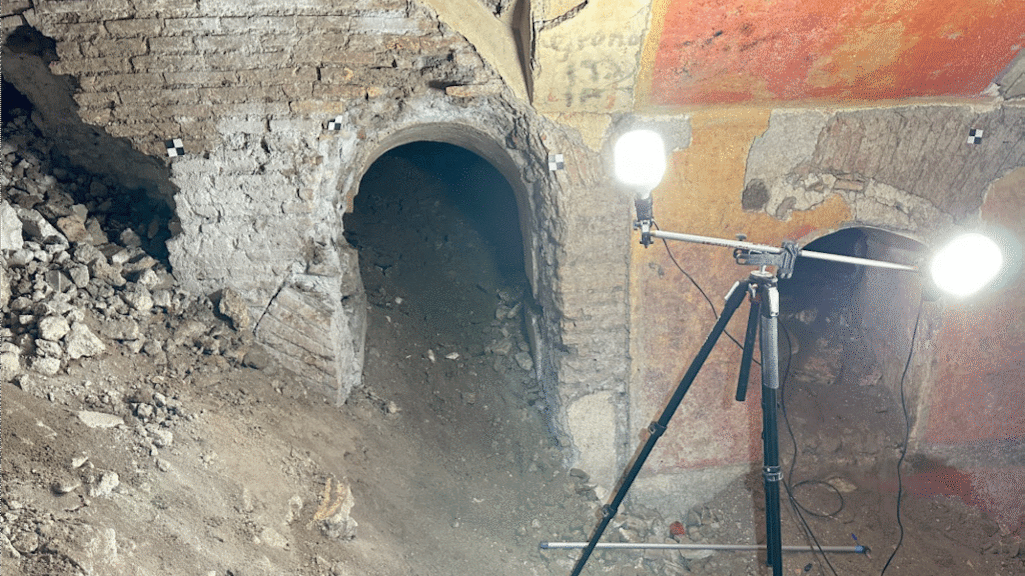 Roman underground ruins of home beneath school, illuminated by floodlights