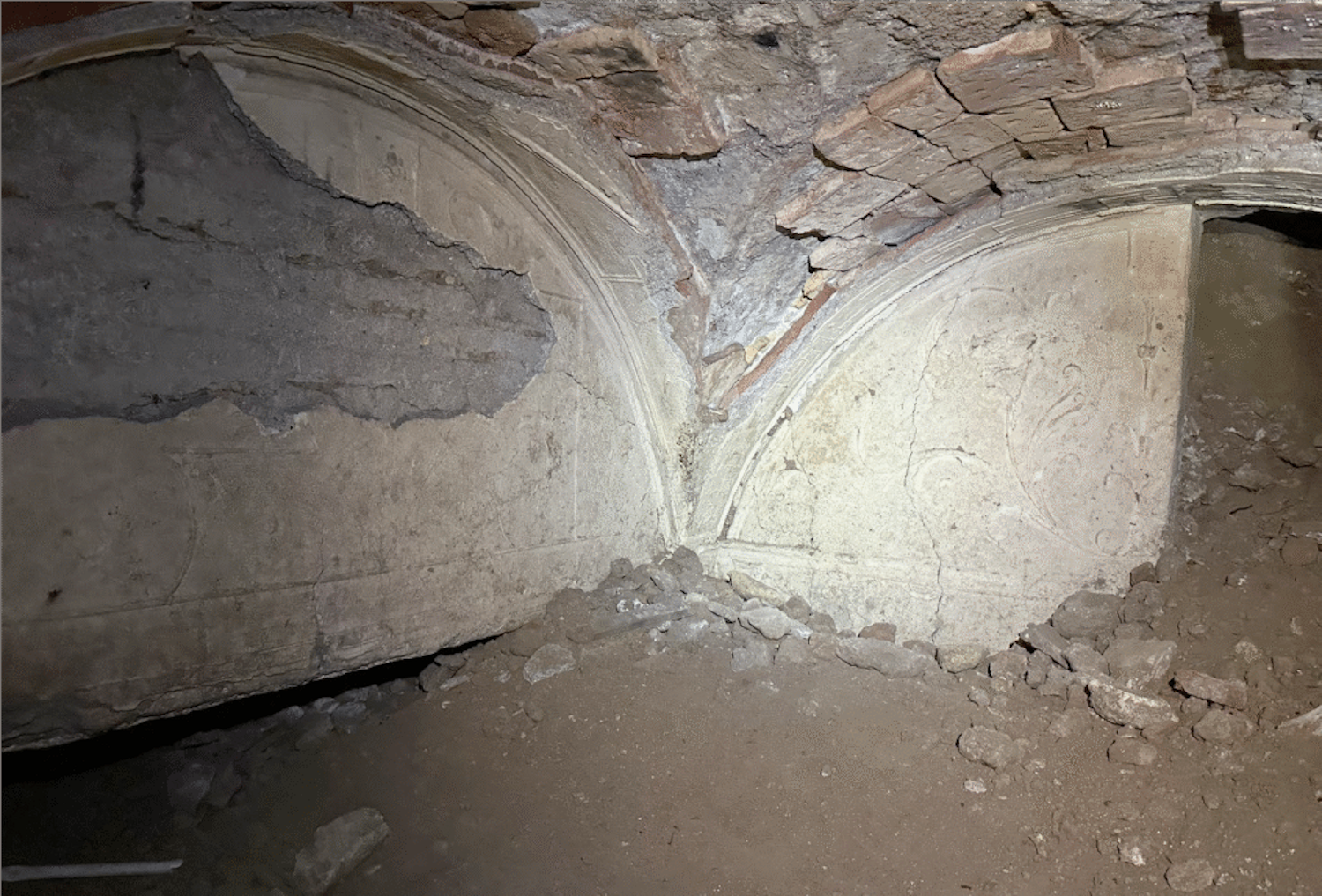 Roman villa walls underground that show light floral motif artwork on walls