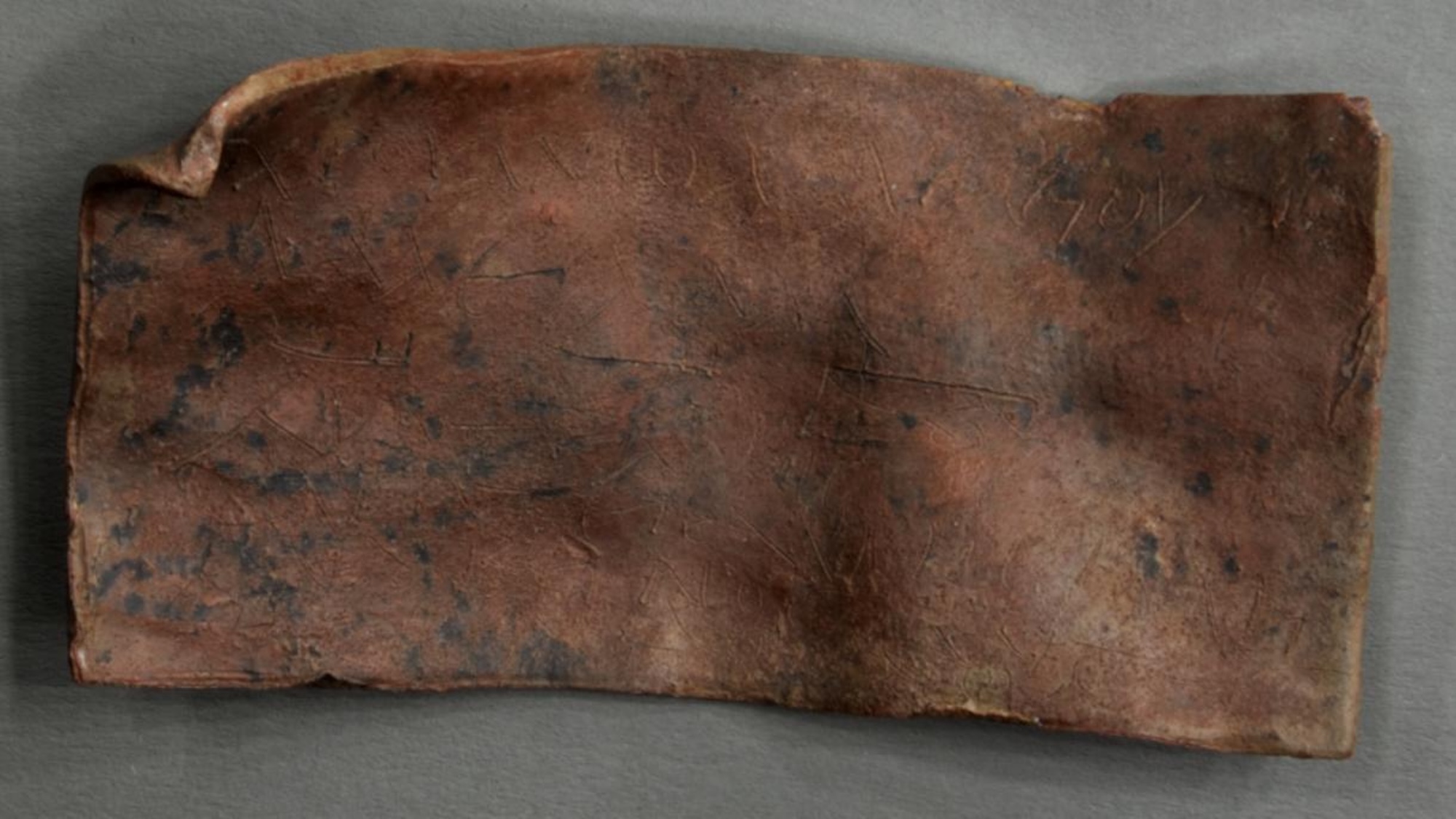 Photo of ancient Roman metal curse tablet
