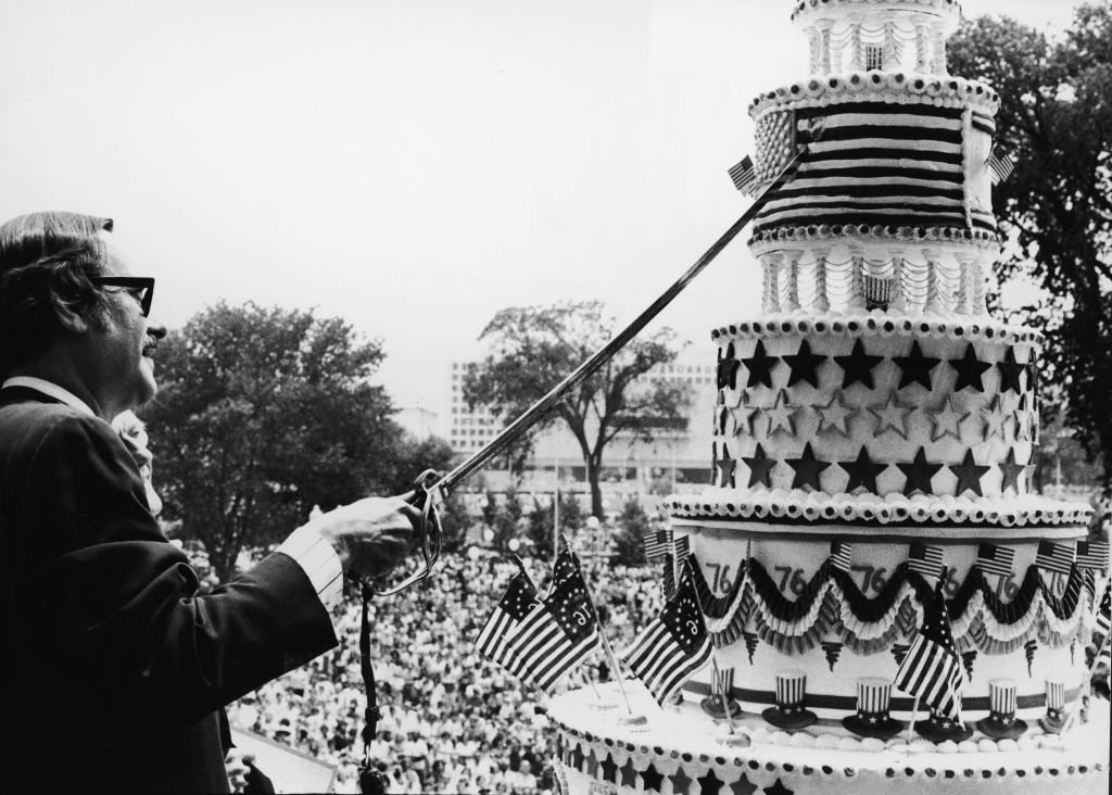 Dr James B. Rhoads, United States archivist, cuts the giant birthday cake honoring the 200th Anniversary of the signing of the Declaration of Independence during the American Bicentennial ceremonies, Washington, D.C., July 4, 1976. (Photo by Pictorial Parade/Getty Images)