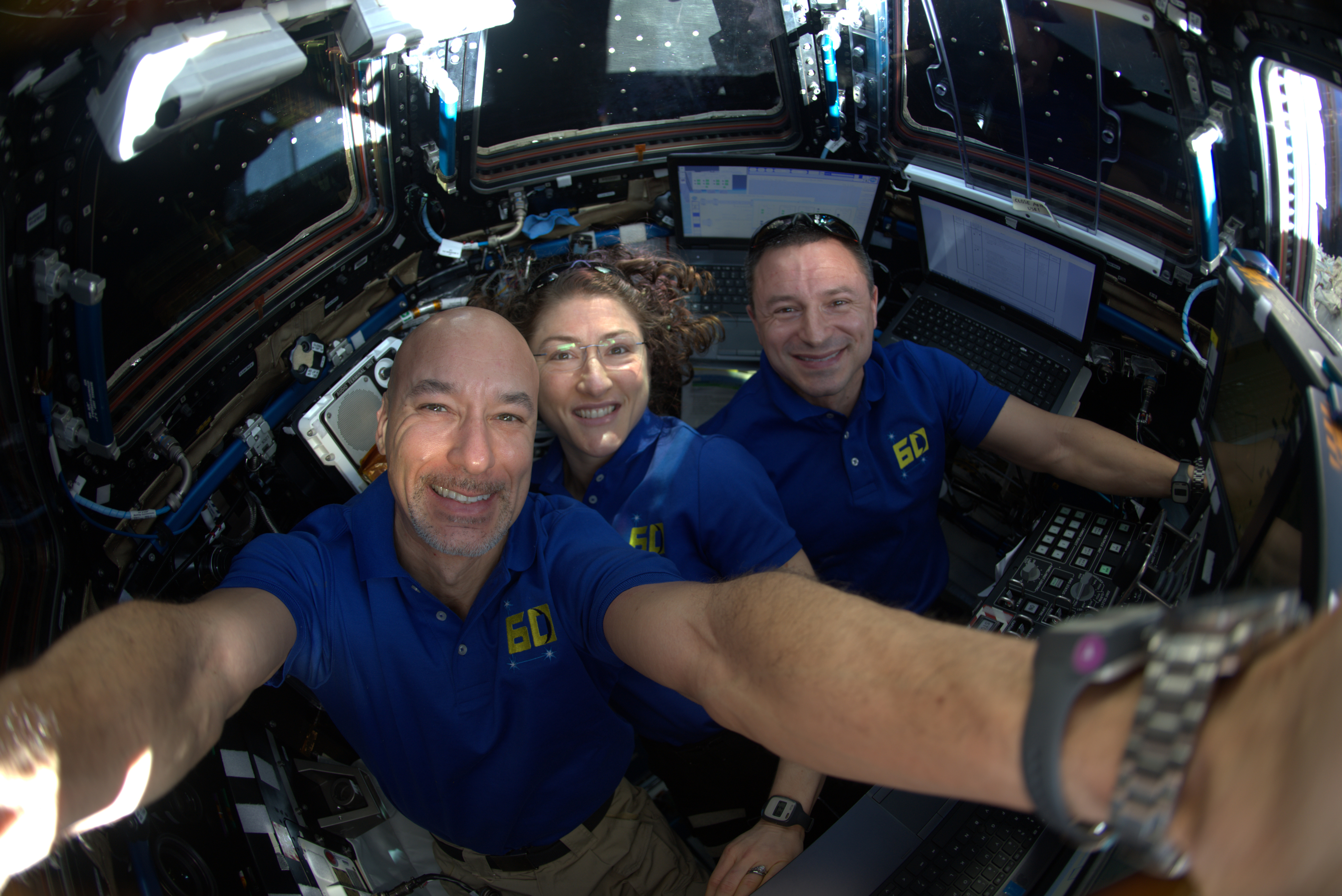 three astronauts pose for a selfie