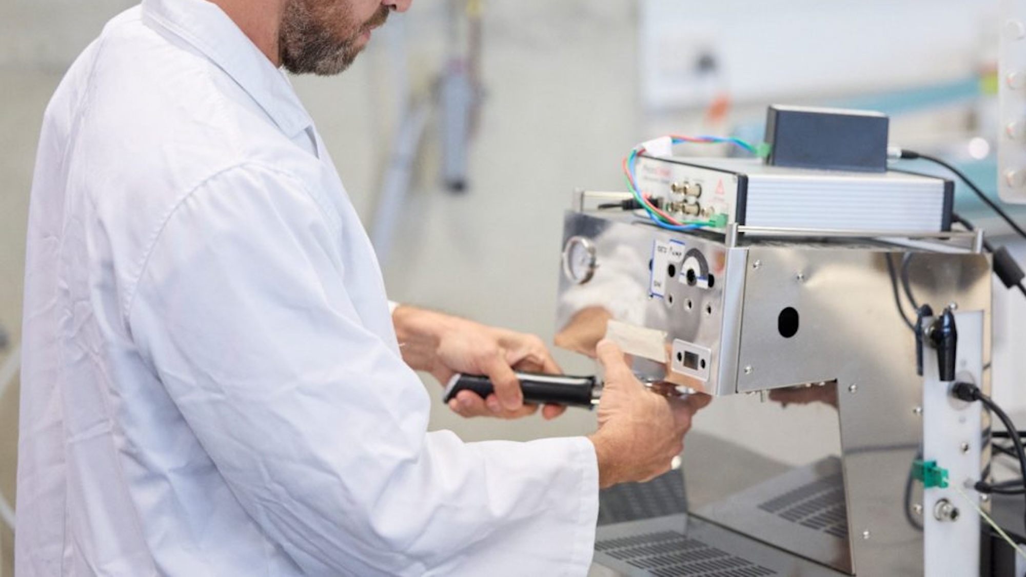 Scientist using ultrasonic espresso brewing machine in lab