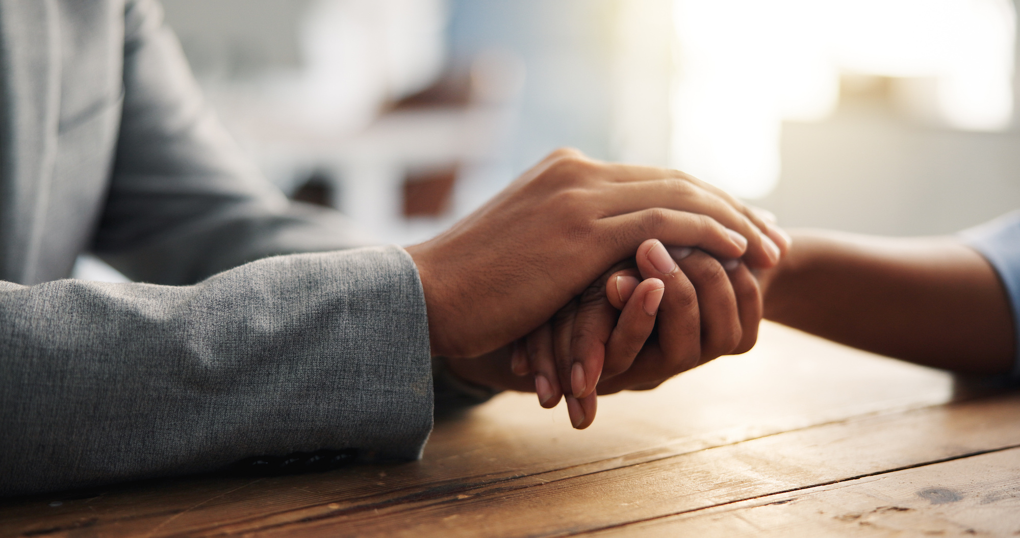Holding hands, support and people with empathy, comfort and compassion for healing. Closeup, care and sympathy with connection, hope and process for loss, grief and trust to connect or help in crisis.