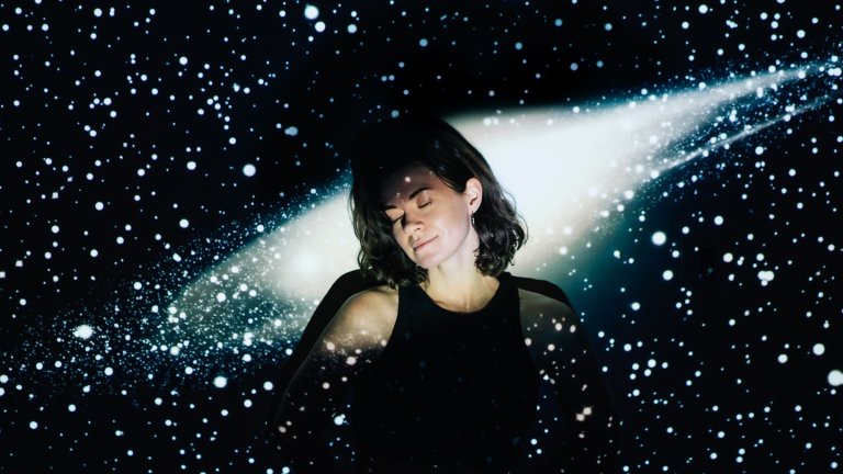 Image projection of space on a young beautiful woman with short curly hair.