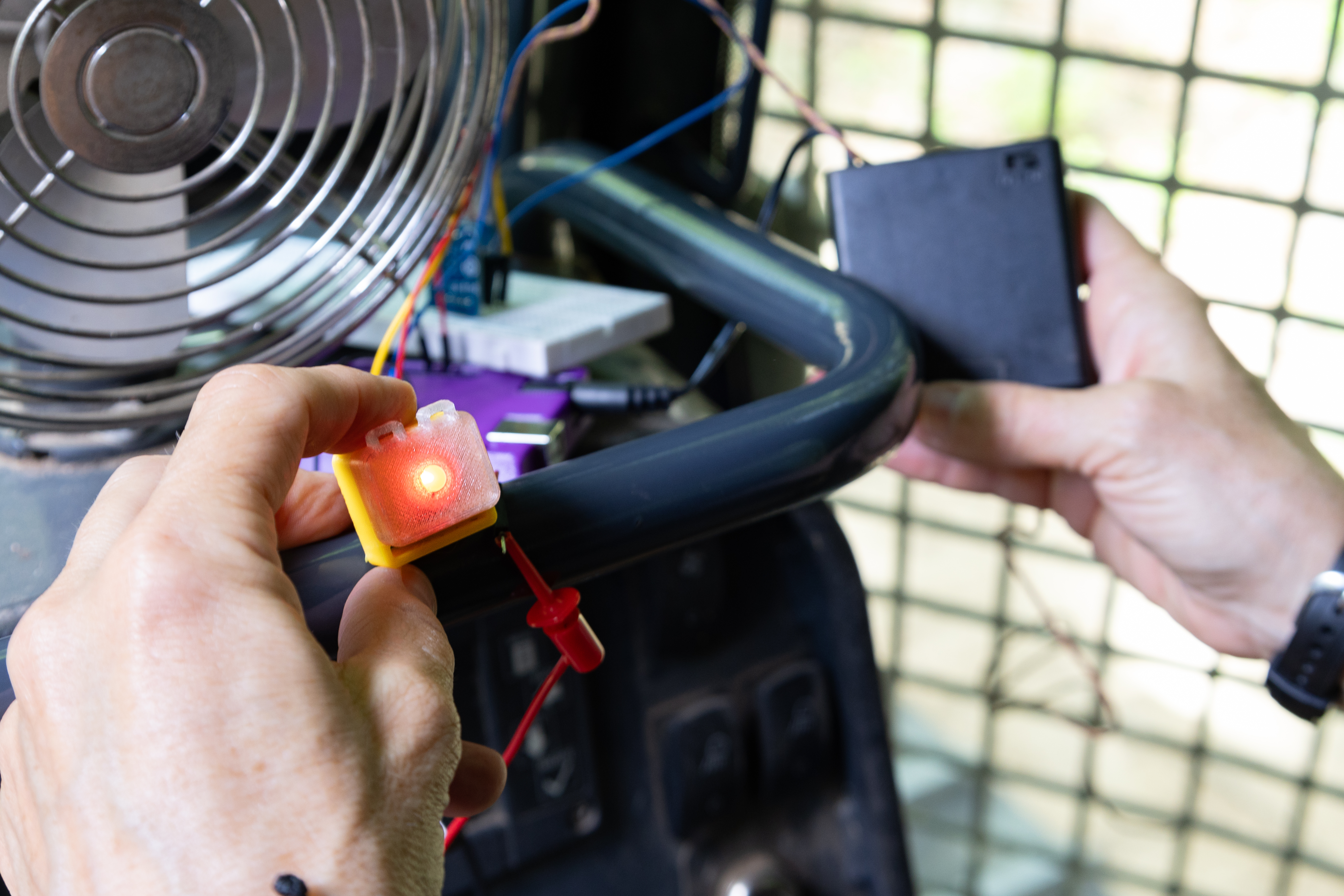 a sensor with a red light being placed on a bullzoser