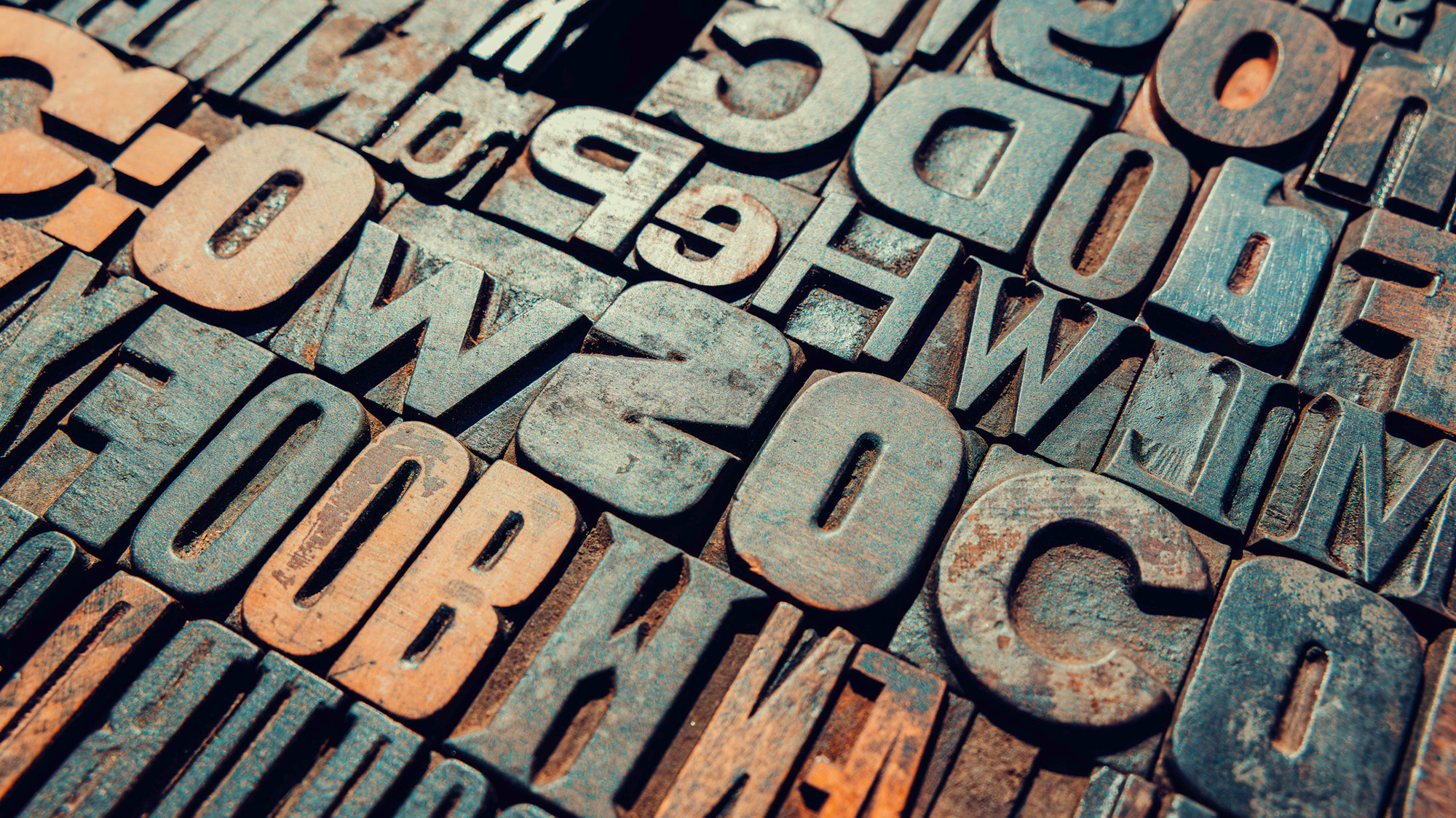 Vintage printing blocks showing letters and numbers creating a textured background