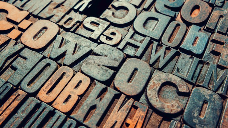 Vintage printing blocks showing letters and numbers creating a textured background