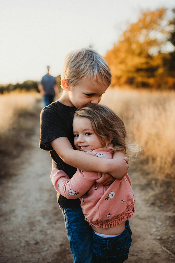Hugs Photo of boy hugging girl on a trail.