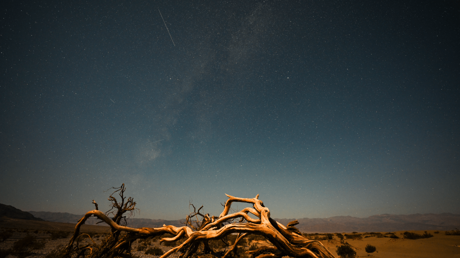 a meteor falls over a desert