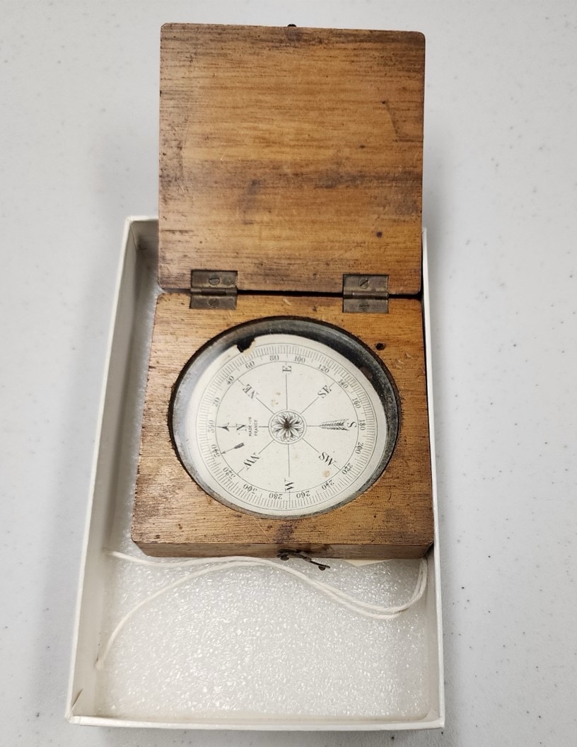 a compass in a wooden case