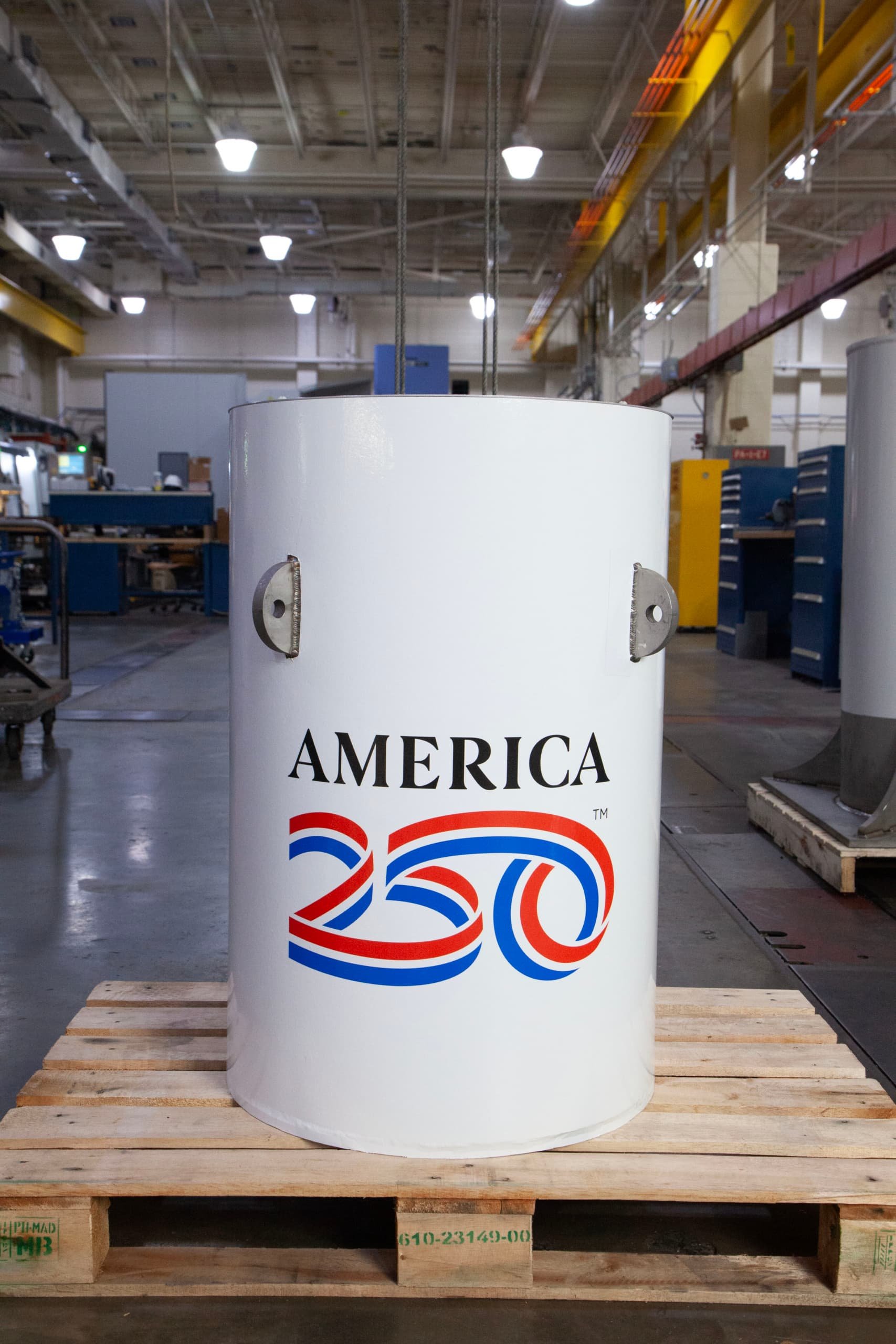 a long white time cylinder with the text Amerca250 on it