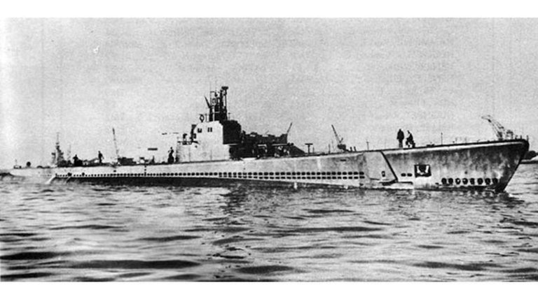 a black and white photo of a submarine floating on top of the water