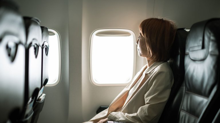 Businesswoman traveling on an airplane to a business destination