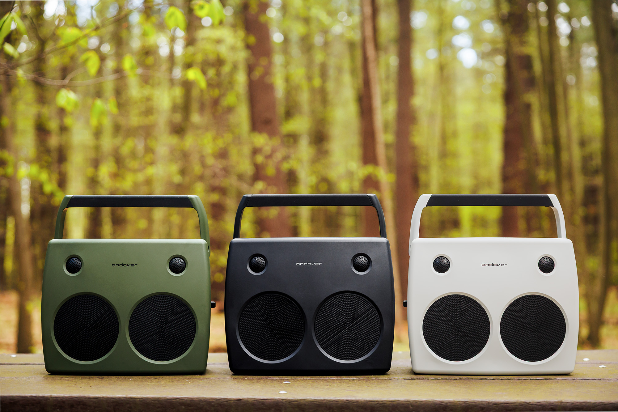 The Andover Sound FreePlay portable stereo Bluetooth speaker shown in Olive, Slate, and Ivory colorways against a woodland background