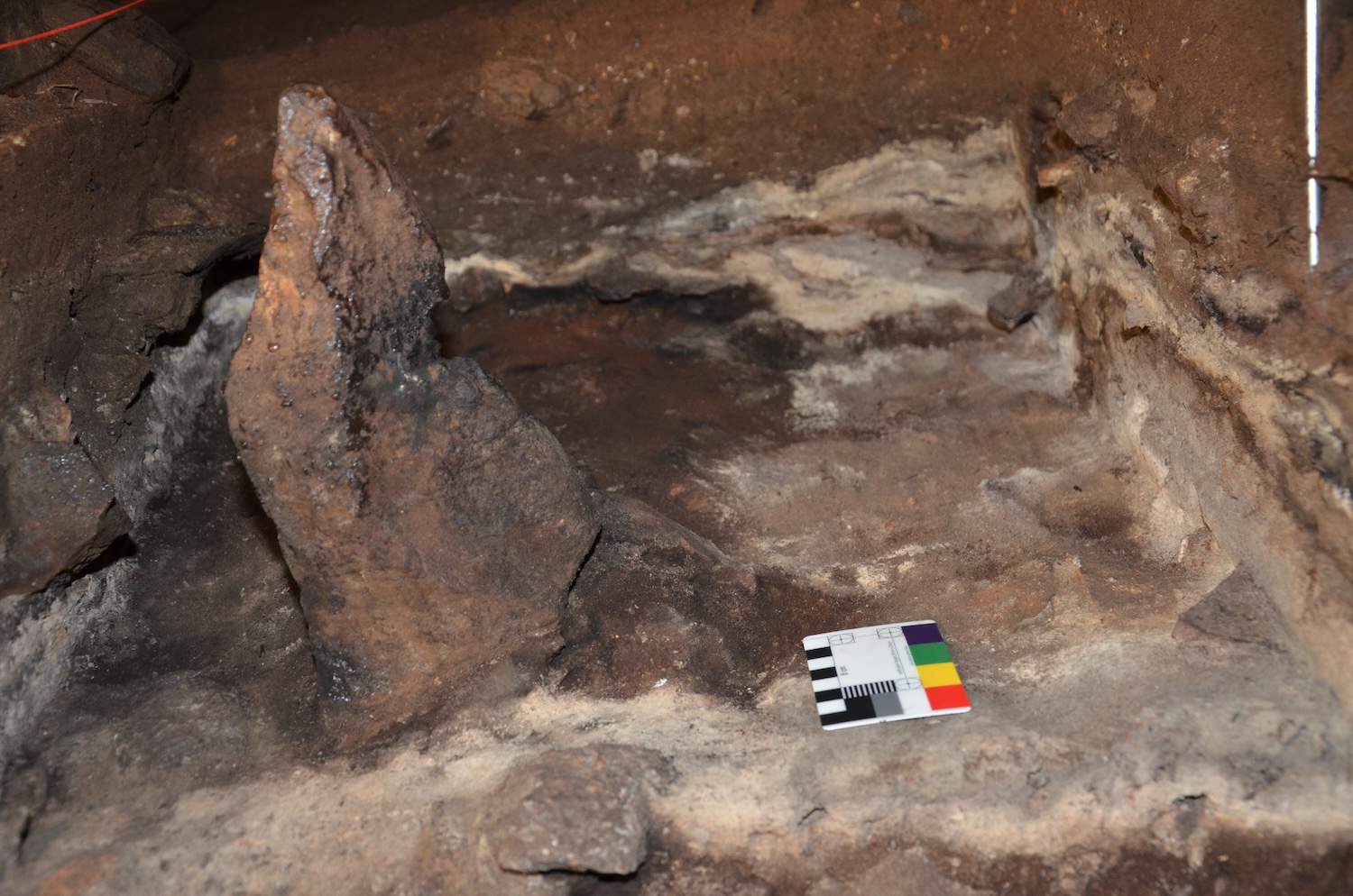 A 2,000 year-old standing stone, depicted during excavations. Burnt phytoliths came from the ashy layers surrounding the standing stone