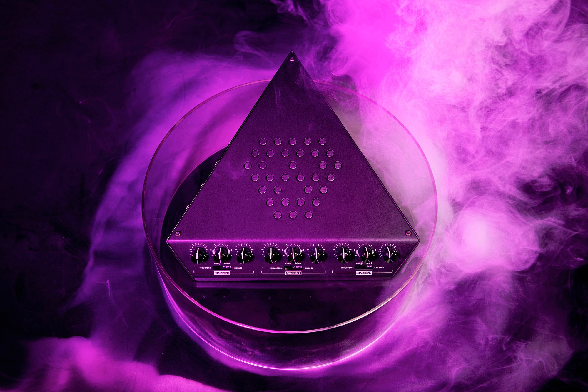 A metallic triangle Eternal Research Demon Box EMF-interpreting interface/instrument in a purple fog.