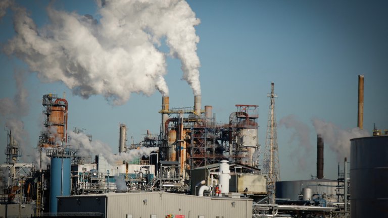 Smoke emanates from smokestacks at the Phillips 66 Bayway Refinery in Linden, New Jersey, on March 18, 2026. Oil prices surged Wednesday following a strike on a major Iranian gas facility as the Federal Reserve raised its inflation forecast while holding interest rates steady. (Photo by kena betancur / AFP)