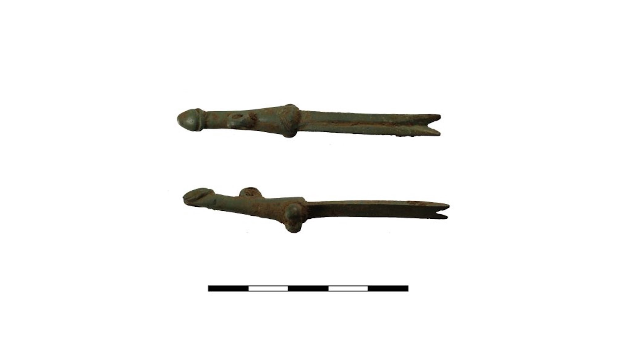 Two angles of a phallic themed copper nail cleaner from ancient Rome